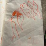 Picture shows a page form a handmade story with  a scribble and sentence written from the adult.